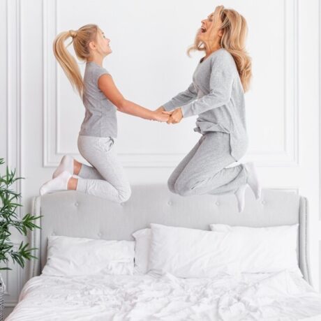 mother-daughter-jumping-bed_23-2148334839