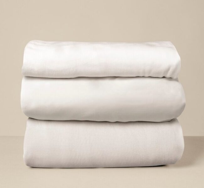 stacked-white-bed-linen_53876-146633